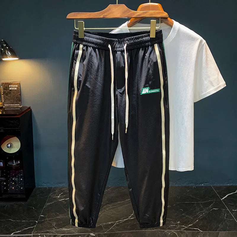 Men's solid colour cotton harem pants in black or grey, showing mid-waist and straight leg design