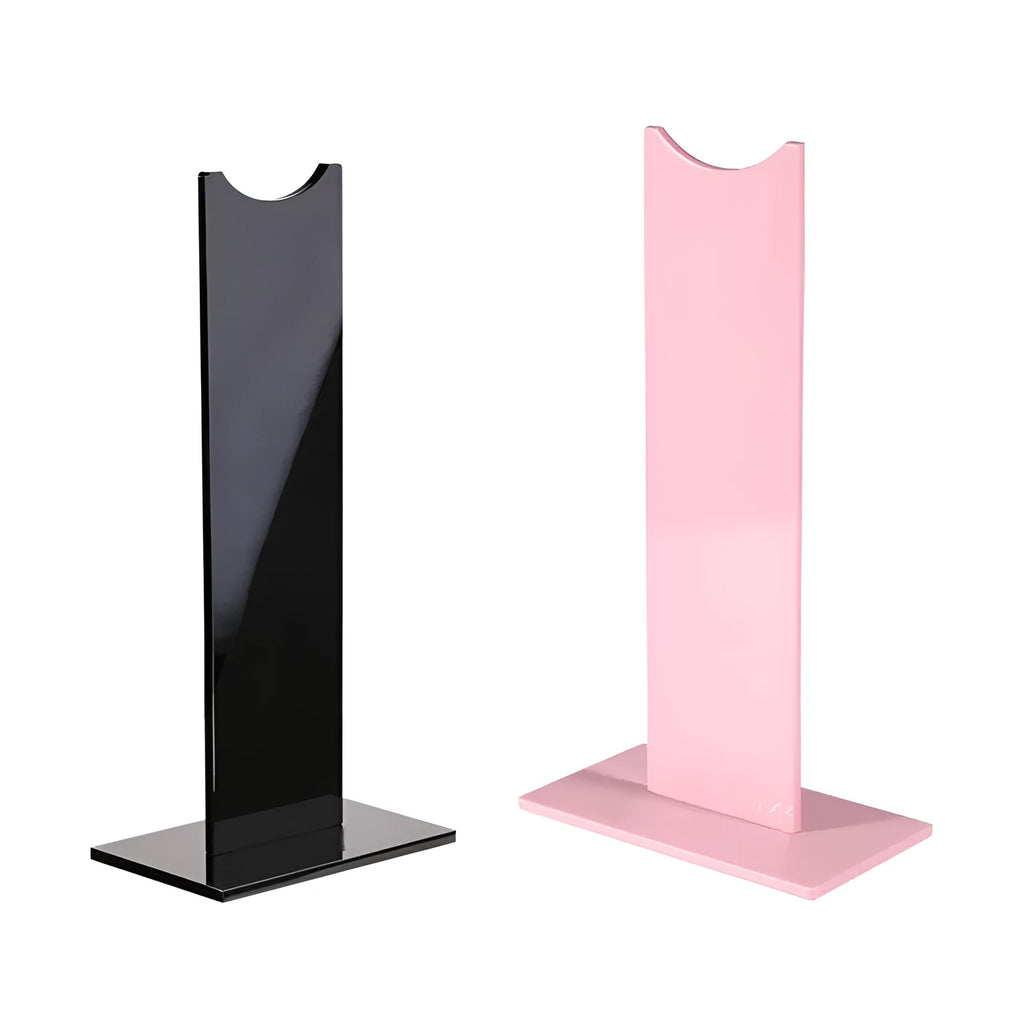 Pink and black detachable head-mounted headphone stand on a desk with a non-slip silicone base.