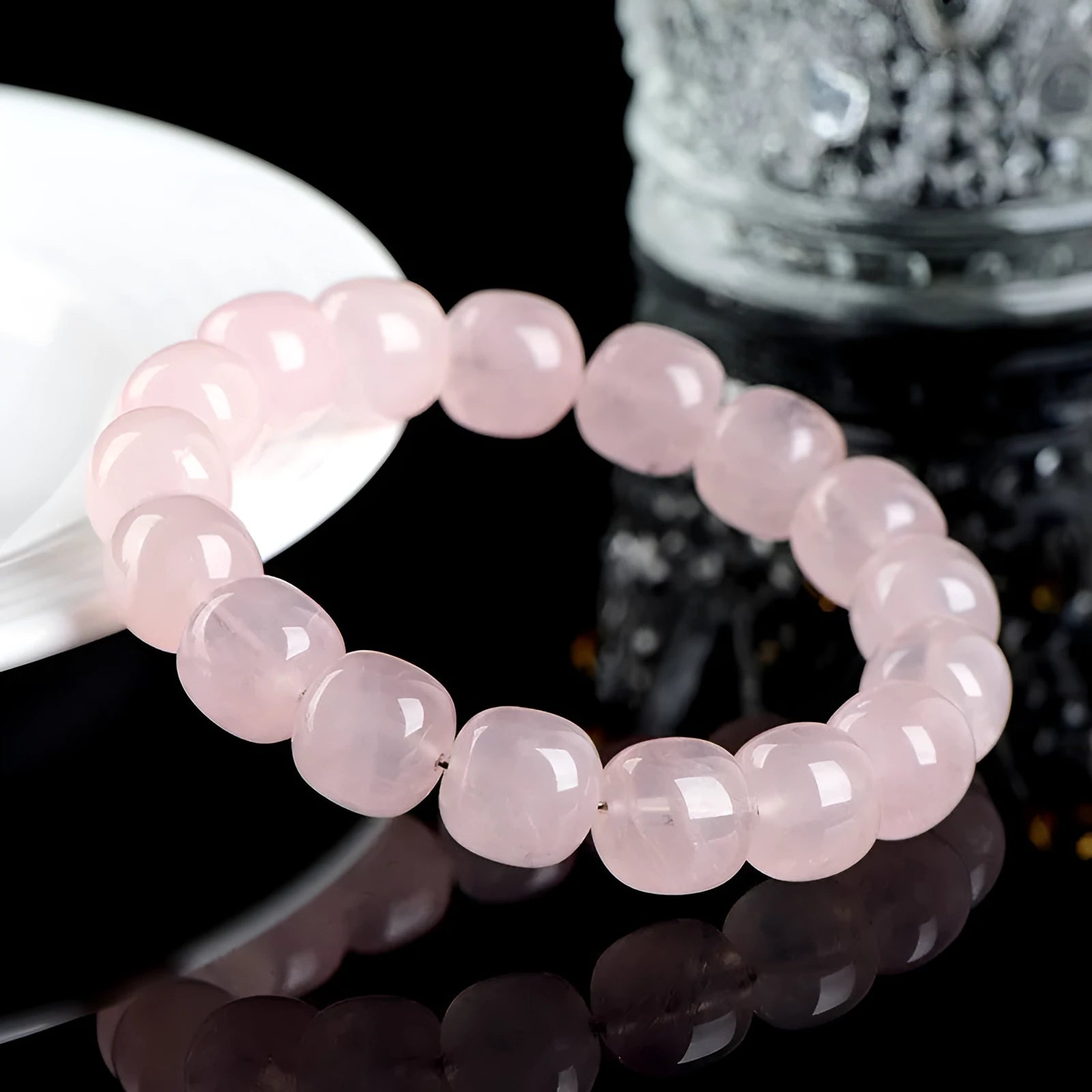Pink crystal barrel bead bracelet with 11mm to 12mm geometric beads on natural background
