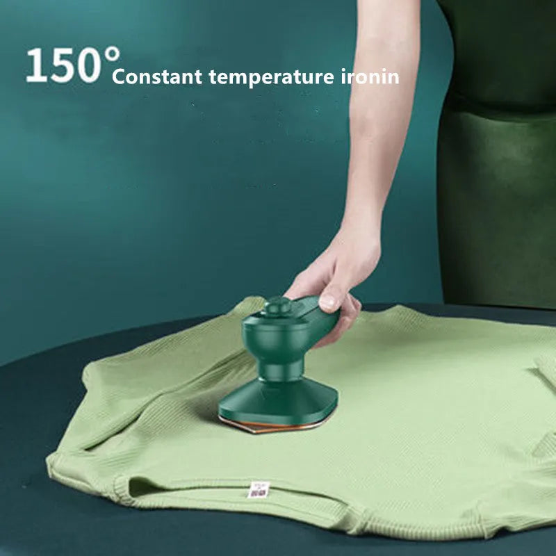 Dark green portable hanging steam iron with ceramic panel and power cord.