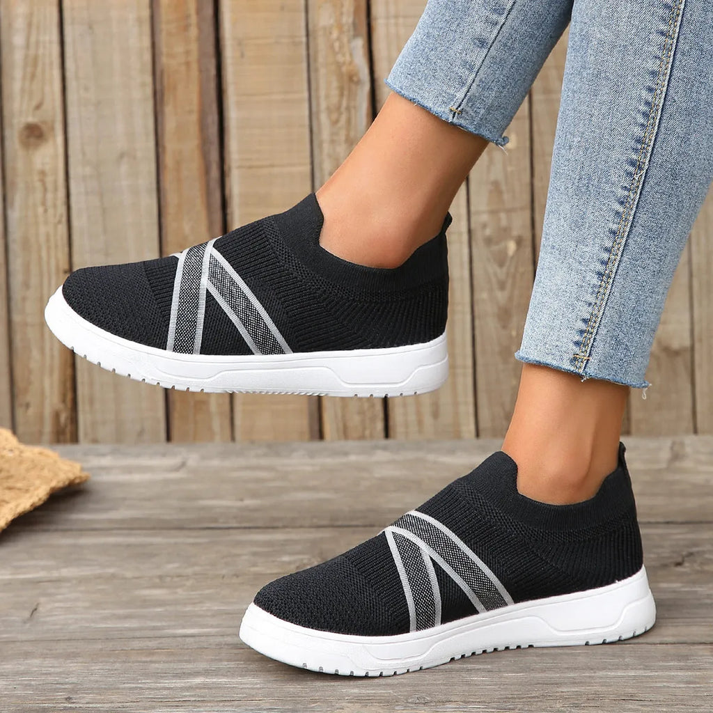Black women's flat mesh shoes with flyknit fabric upper and tassel detail