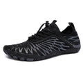 Men's white and black lace-up casual sports shoes with rubber sole on a plain background