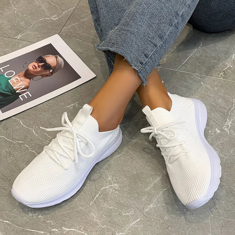 Women's low-top mesh running shoes in creamy white with a rubber sole and round toe.