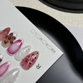 Hand-painted 3D candy pattern false nail art patches in almond shape on a plastic set.