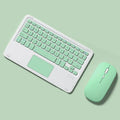Pink wireless Bluetooth keyboard and matching dual-mode charging mouse on a desk