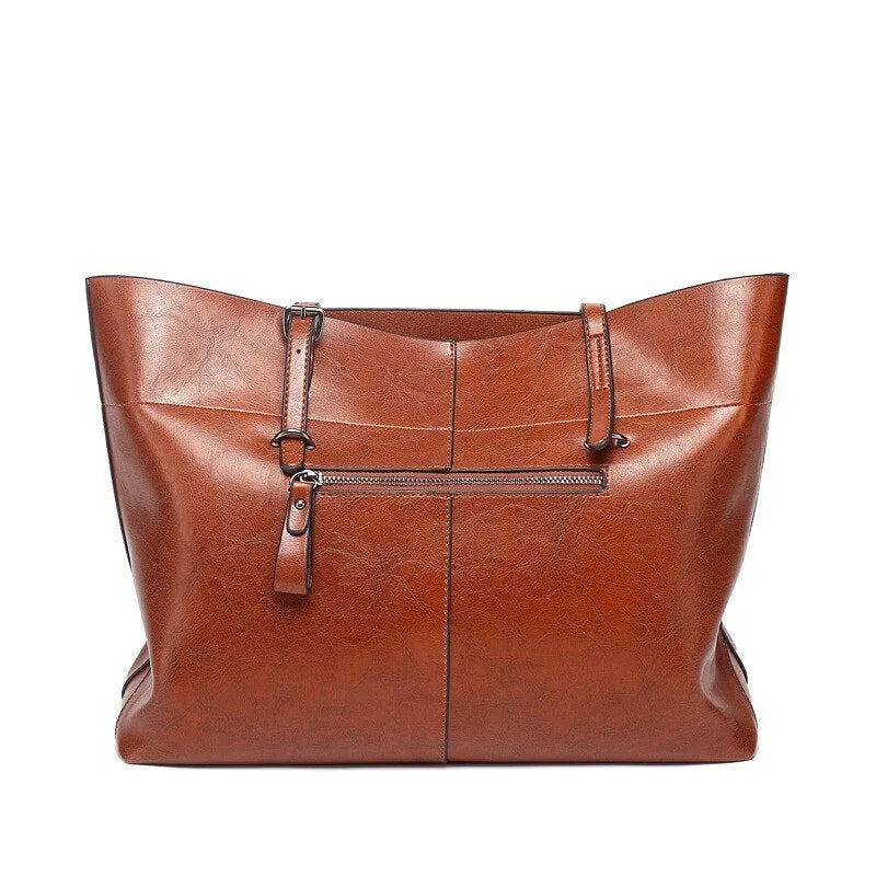 Brown wax cowhide leather handbag showing internal compartments and crossbody strap