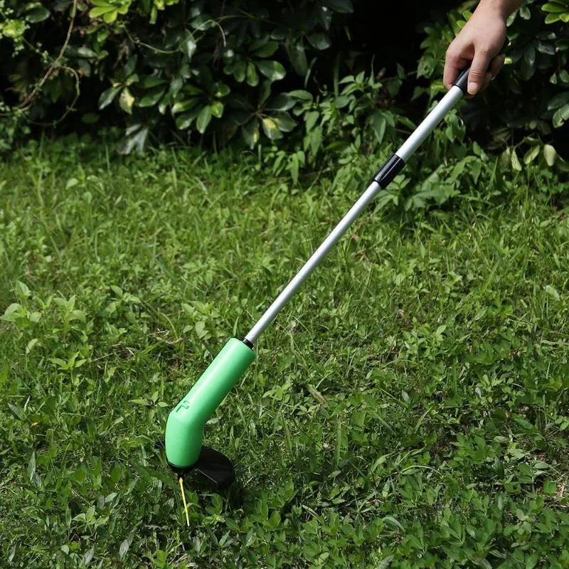 Cordless lawn trimmer with extension pole and protective shield on a garden background