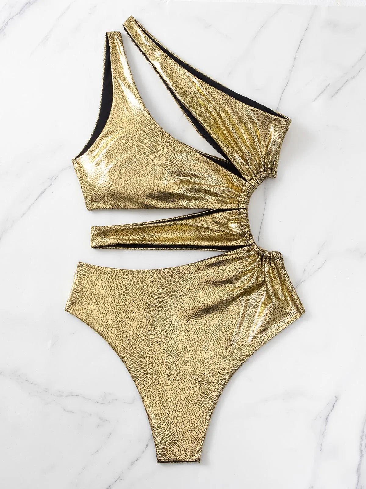 Women's gold backless one-piece swimsuit with sleeveless design on mannequin