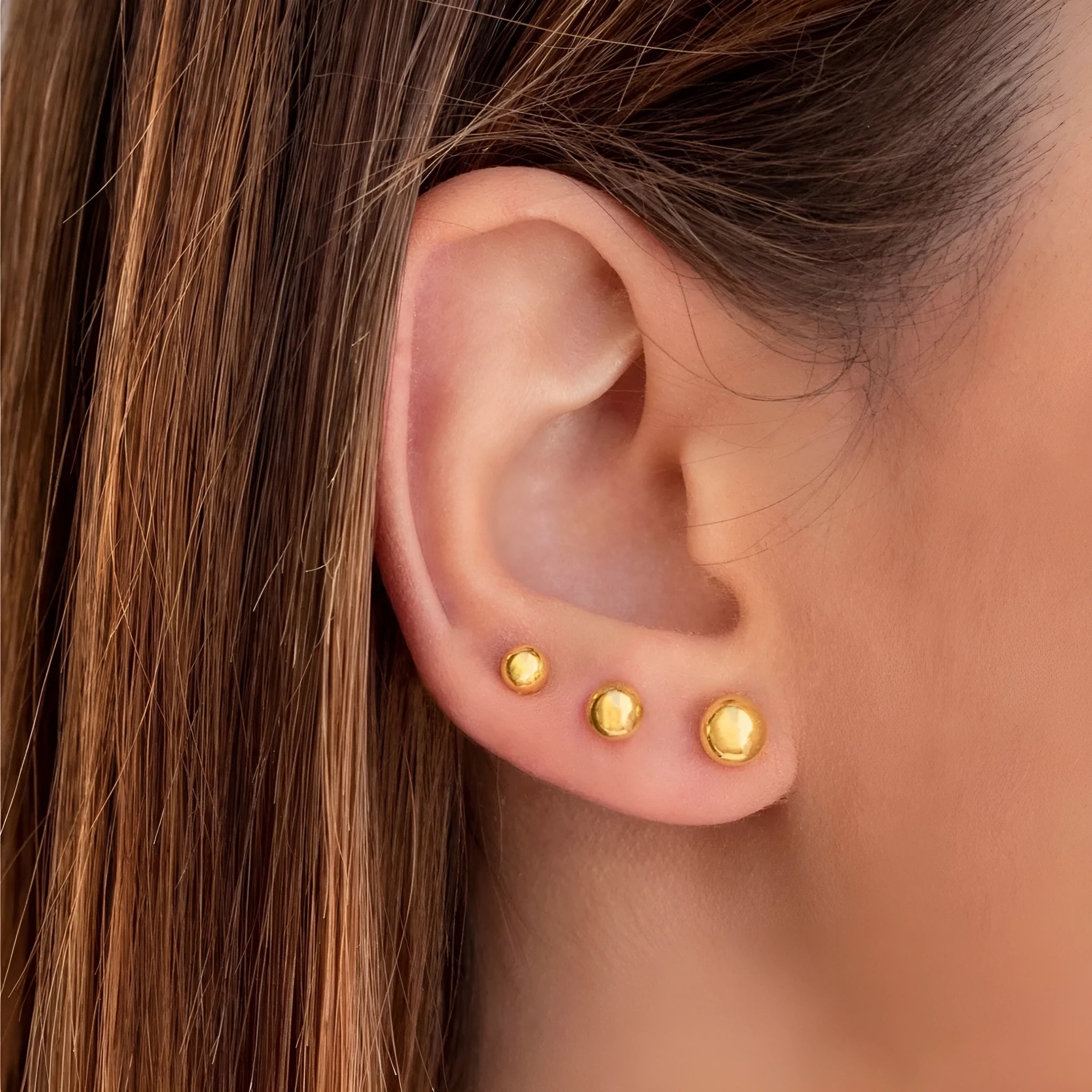 Stainless steel ball stud earrings in gold and silver finishes, showing 3mm to 6mm size comparison