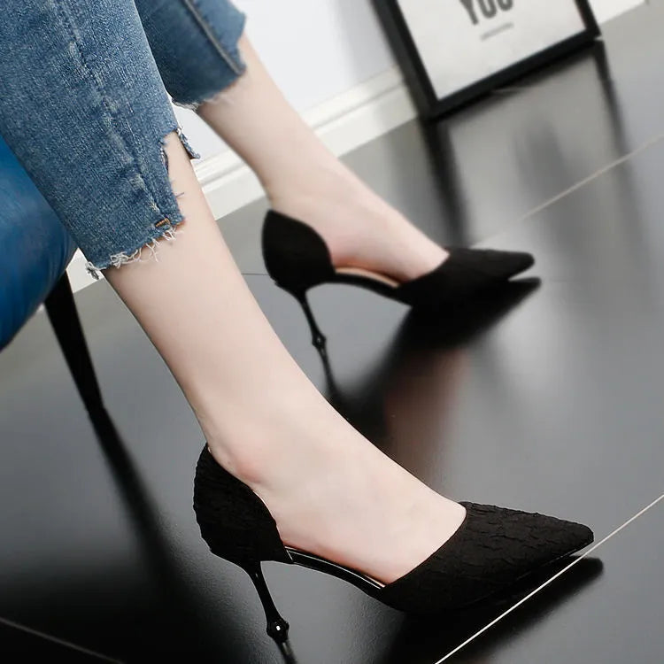 Women's black pointed toe stiletto high heels with a leather upper and thin heel.