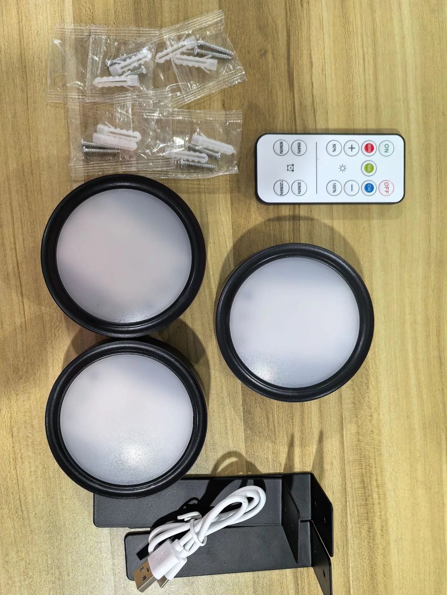 Wireless rechargeable LED painting lamp with magnetic belt attached to a metal frame, remote control nearby.