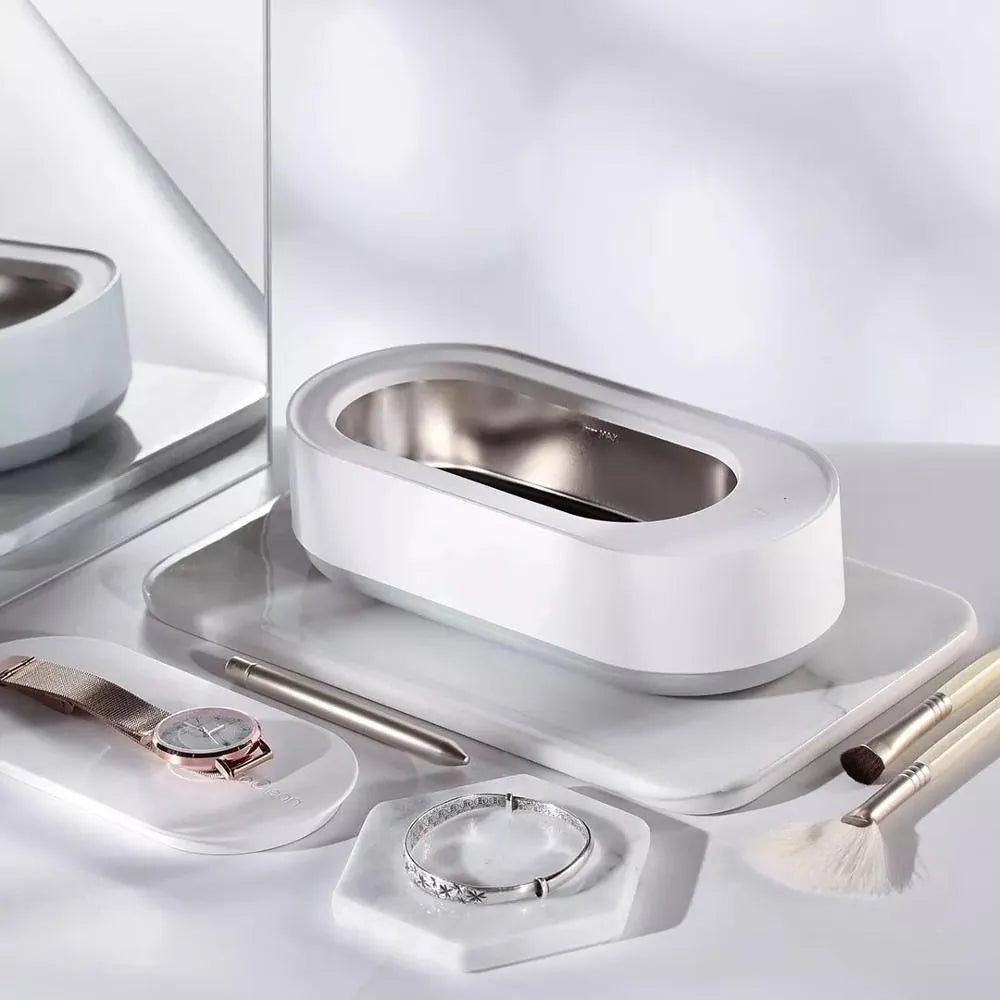 White portable ultrasonic cleaning machine with a stainless steel tank for jewellery and glasses.