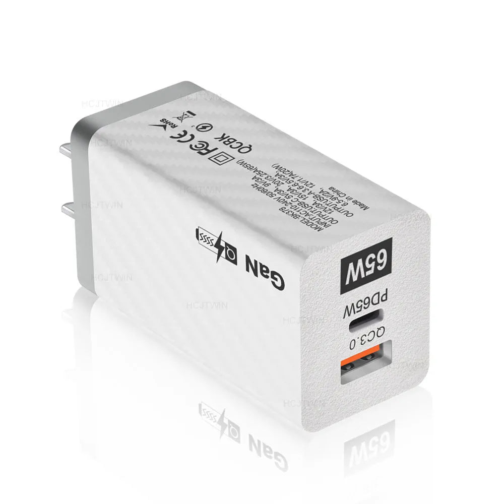 White gallium nitride GaN 65W laptop charger with USB-C port shown next to EU, UK, and US plug options