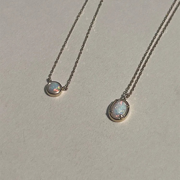 Oval jelly opal pendant necklace on a silver chain with choice of gold or white gold finish.