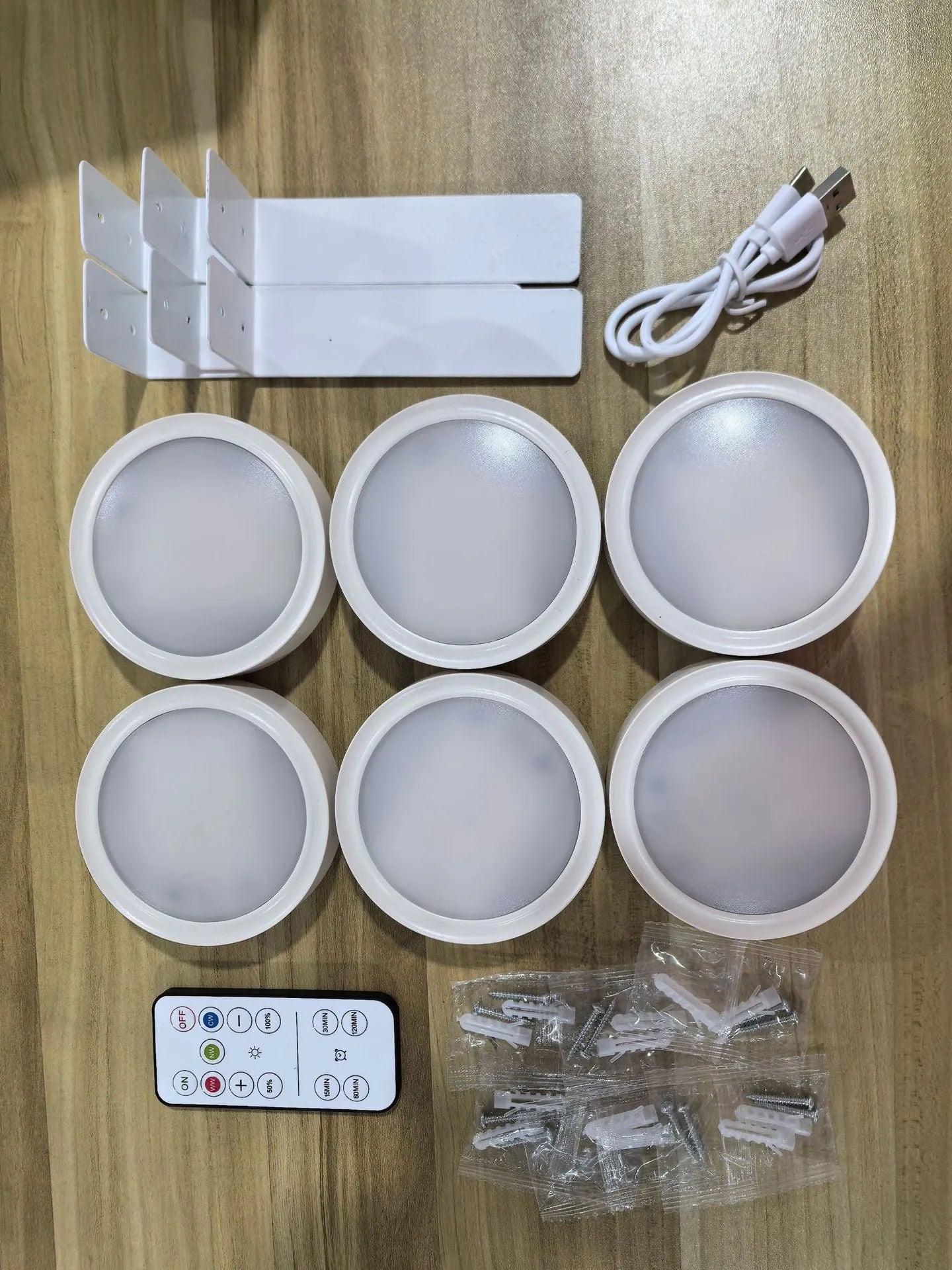 Wireless rechargeable LED painting lamp with magnetic belt attached to a metal frame, remote control nearby.
