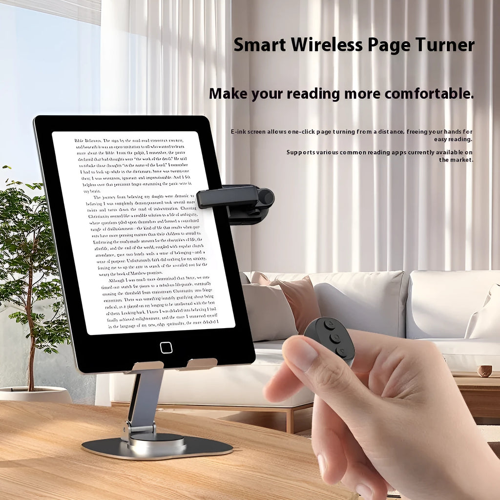 A black wireless page turner remote control and a separate clicker unit on a wooden desk.