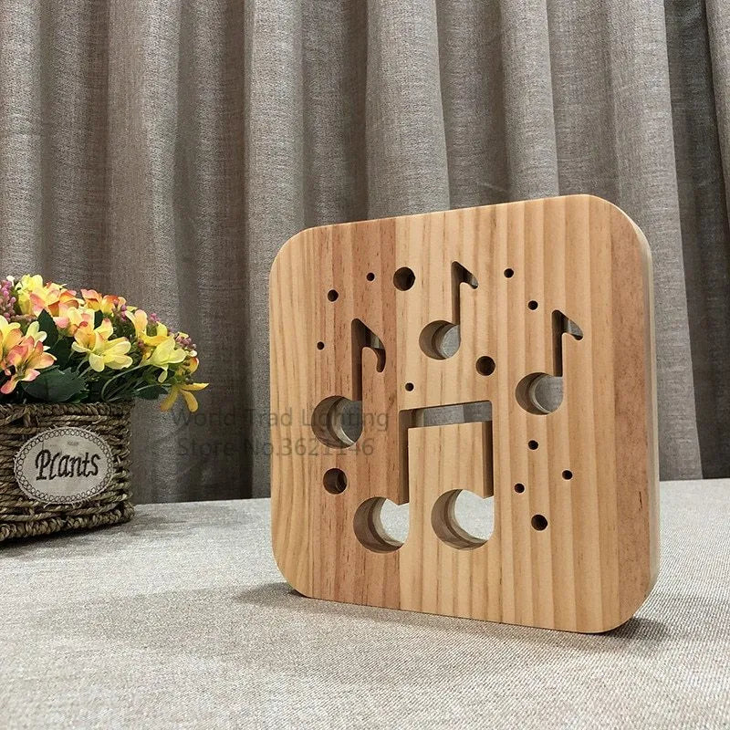 Square pine wood USB lamp emitting a warm white 3D patterned light on a surface.