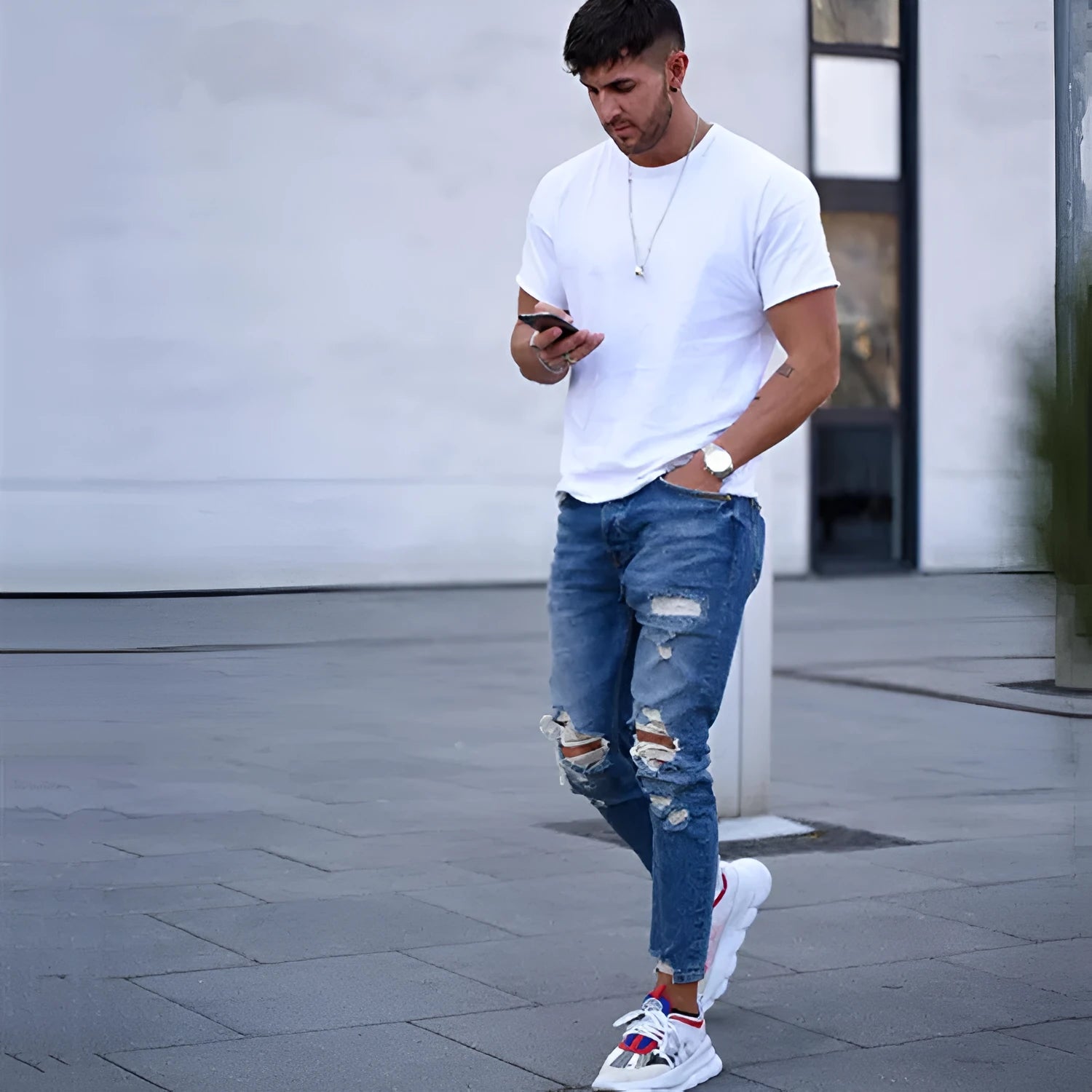 Deep blue men's jeans with hole detailing made from cotton fabric
