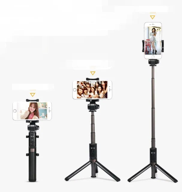 Aluminium Bluetooth selfie stick with tripod base and remote control next to a smartphone.