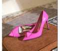 Pink patent leather women's pointed toe stiletto high heels with a buckle.