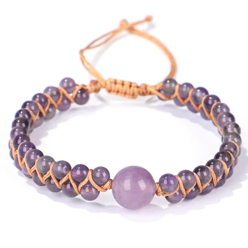 Handmade woven pull bracelet in blue Tigereye or amethyst with geometric design on wrist.