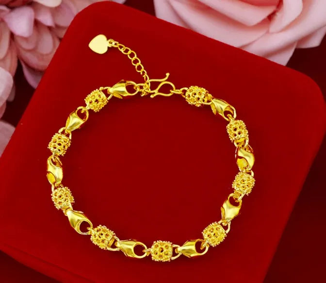 Gold-plated brass bracelet with thick vacuum gold coating on a white background