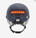 Cycling helmet with integrated red LED tail light and brake light on the rear.