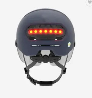 Cycling helmet with integrated red LED tail light and brake light on the rear.