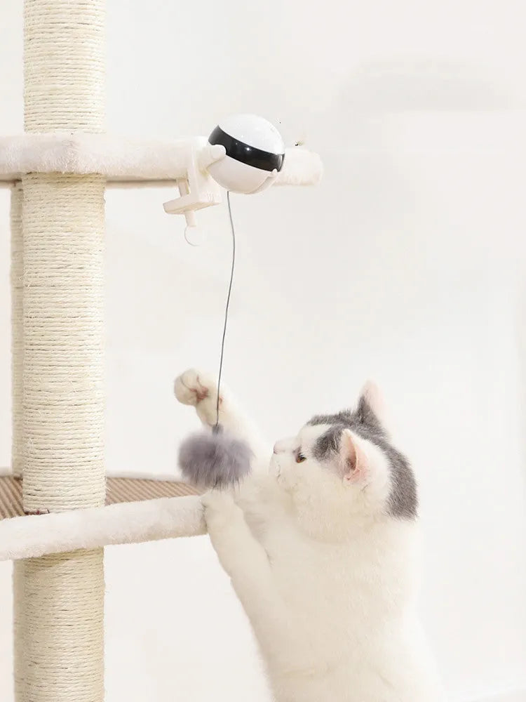 Electric automatic lifting cat toy with rabbit hair teaser and black ABS body on a light floor