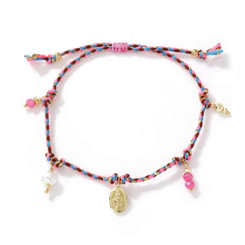 Close-up of a hand-woven colourful braided rope bracelet with an adjustable strap tag, showing ethnic style design.