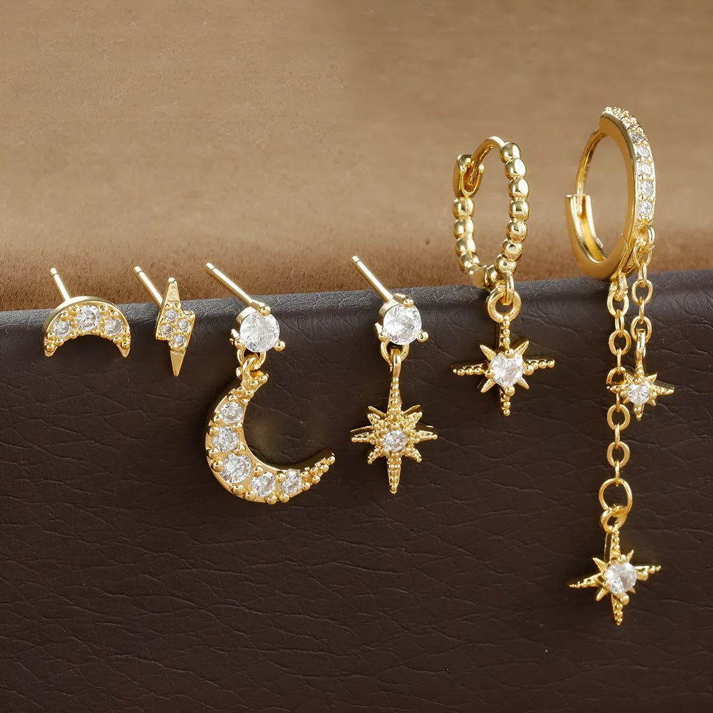Set of six gold-coloured XINGX women's earrings with zircon studs and chain tassels.
