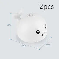 Automatic water spray whale bath toy floating in water with fountain and LED lights