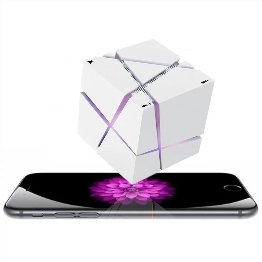 Cube Bluetooth Speaker with colourful lights in black ABS casing, front view on desk