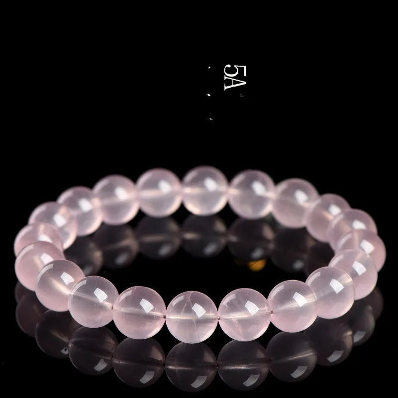 Natural starlight crystal bracelet with round polished pink beads in various size options.