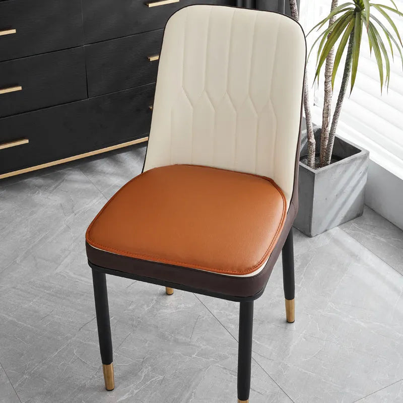 Beige leather horseshoe-shaped seat cushion with anti-slip base on a wooden chair