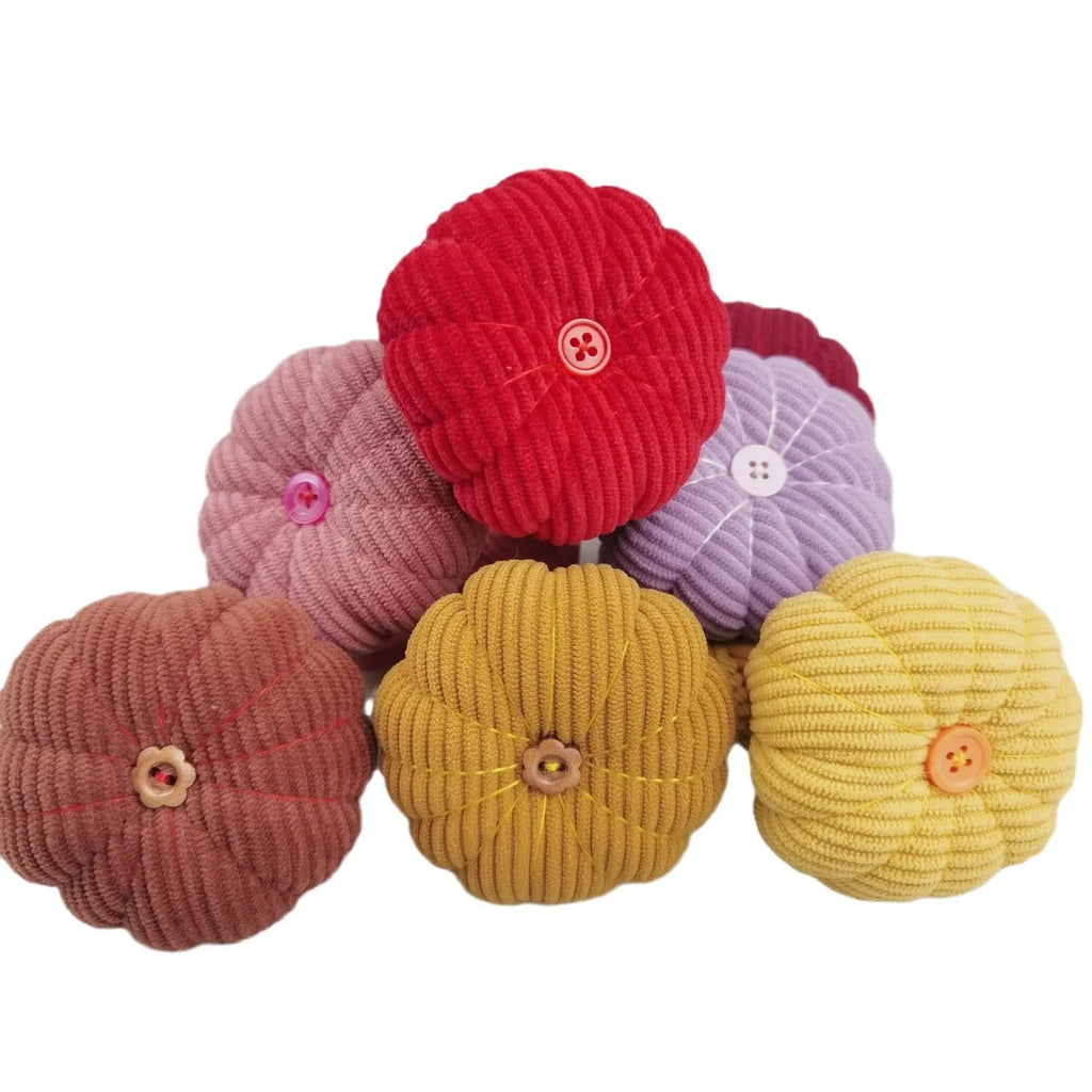 Ring pincushion sewing tool with vertical cutting slot in caramel colour showing fabric cushion and metal ring base