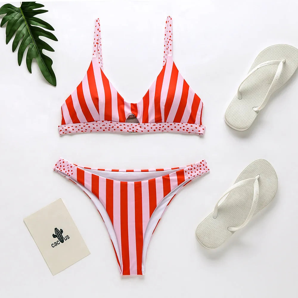 Women's black and white dot polyester bikini set laid flat, showing top and bottom pieces.