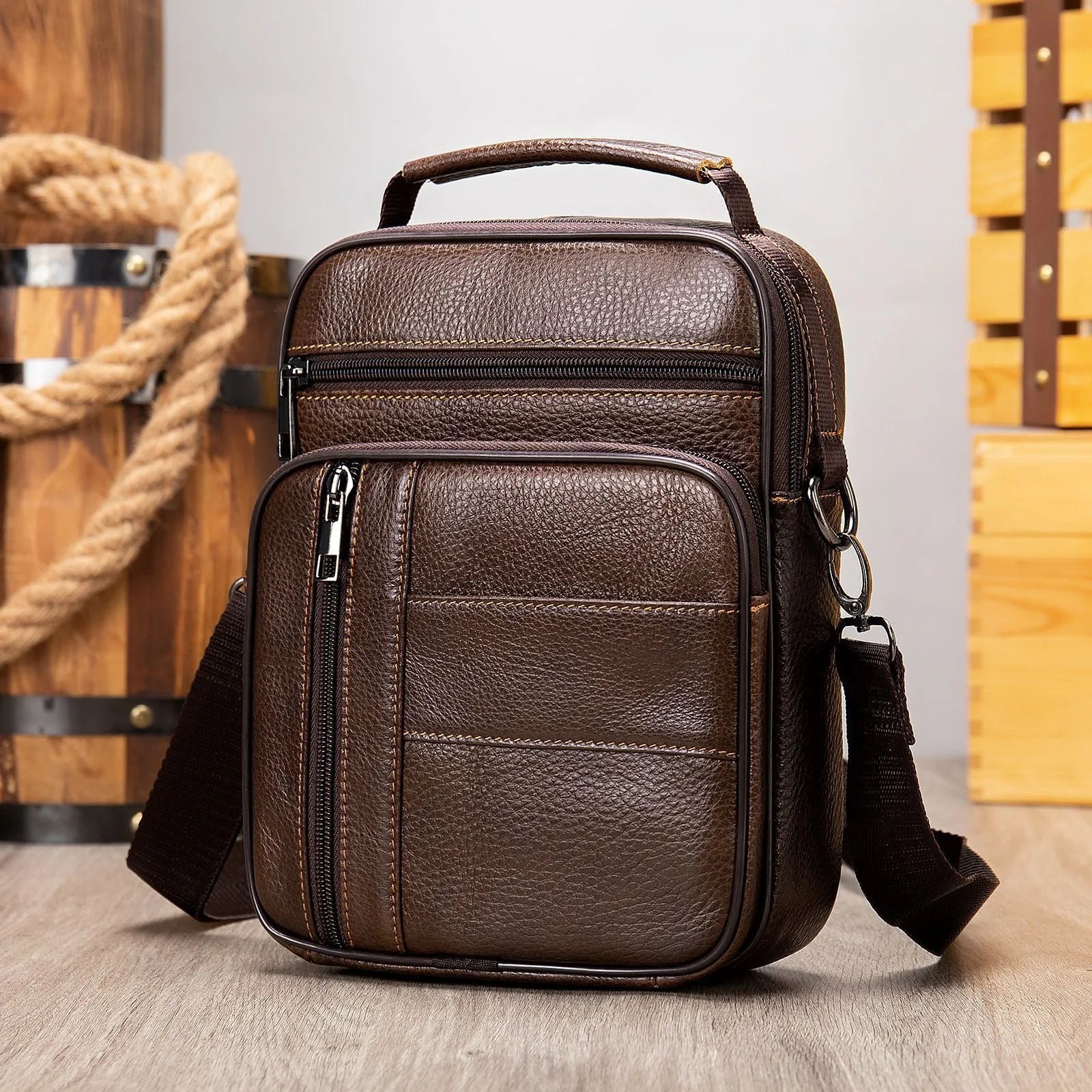 Men's vintage style genuine leather shoulder bag in a square shape with multiple internal pockets.
