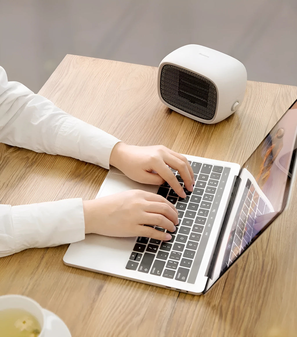 Mini ceramic desk heater in green colour showing compact dimensions
