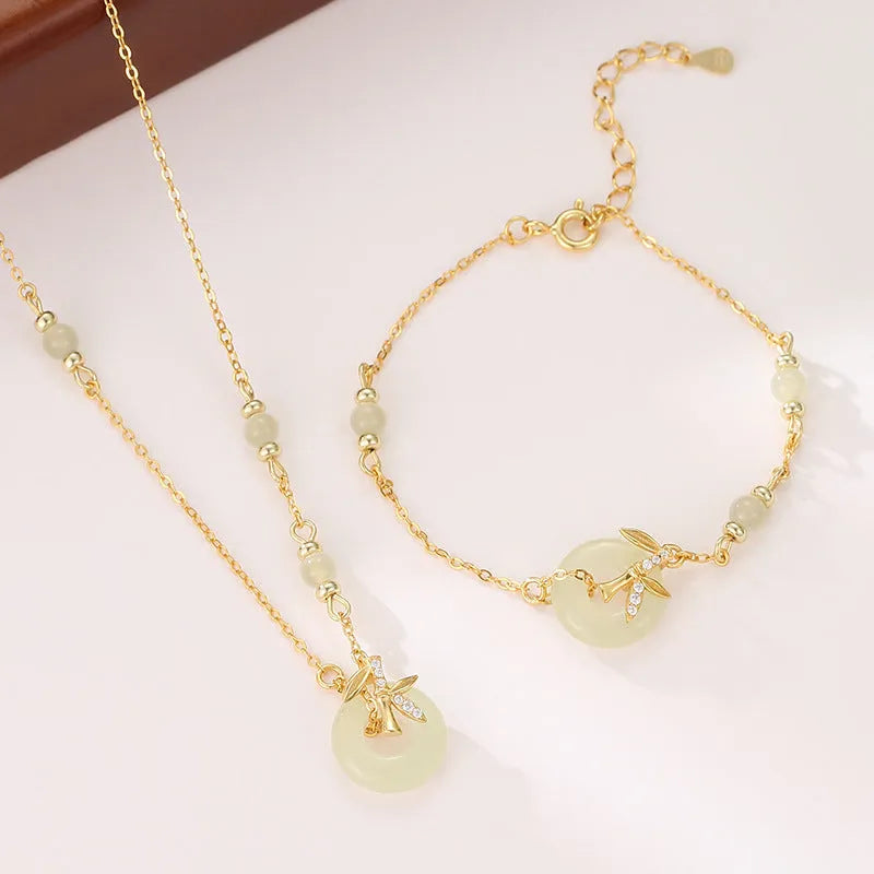Women's antique style Hetian jade bracelet with a silver peace buckle clasp on a wrist.