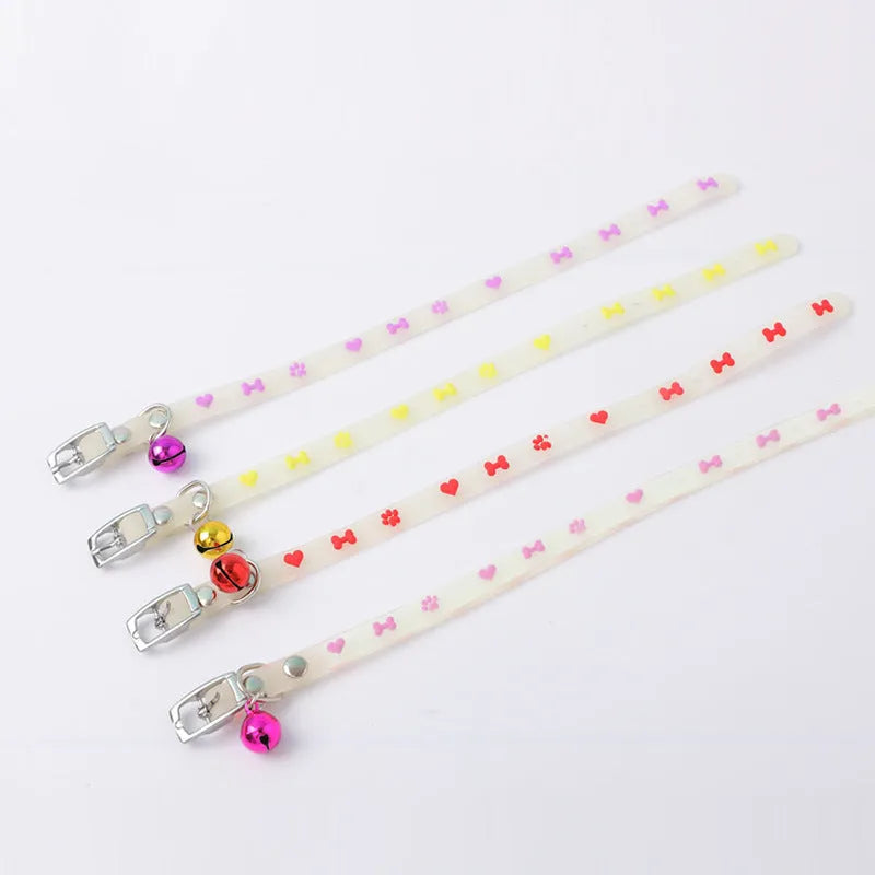 Adjustable cat luminous collar with silicone chain and metal bell showing nighttime illumination