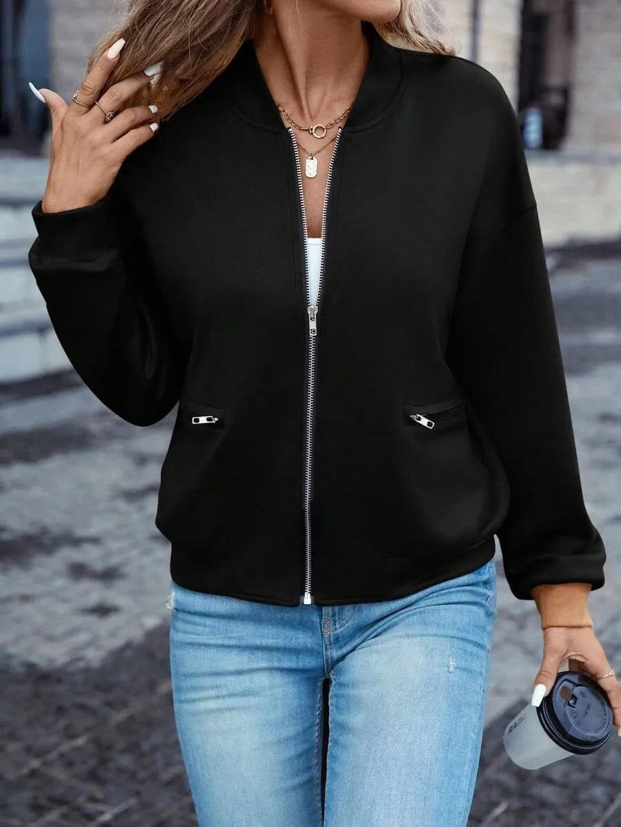 Women's solid black long sleeve zip jacket on a hanger, front view.