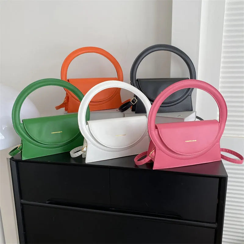 PU leather messenger bag in horizontal square shape with sandwich pockets and stitching details