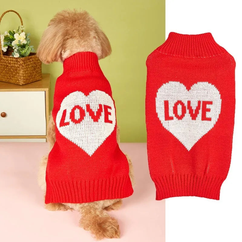Small dog wearing a pink acrylic sweater with a bow and love heart design in ins style
