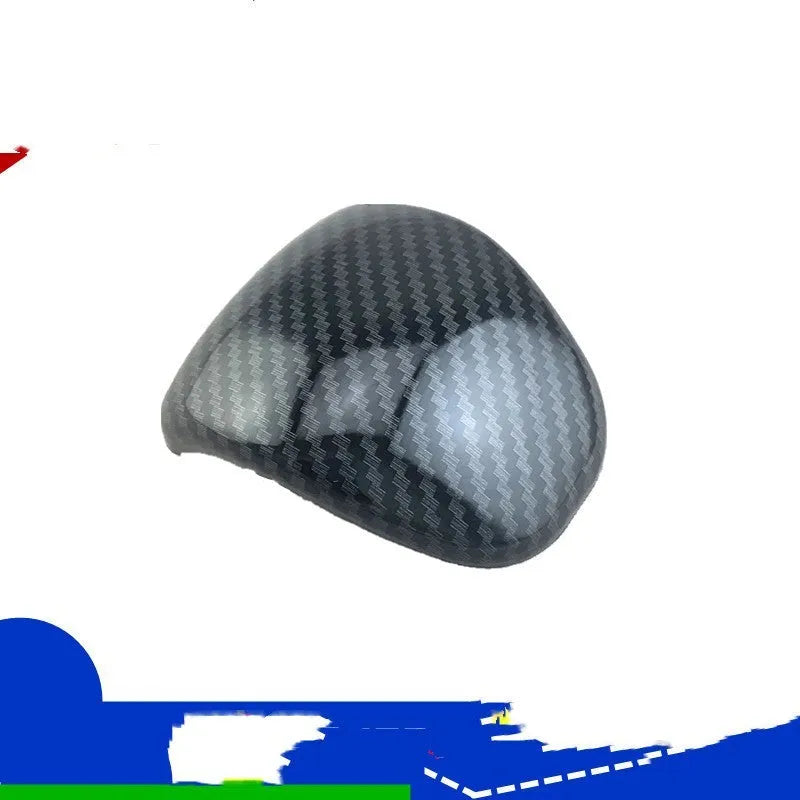 Black carbon fibre pattern gear shift cover for car interior with textured anti-slip surface