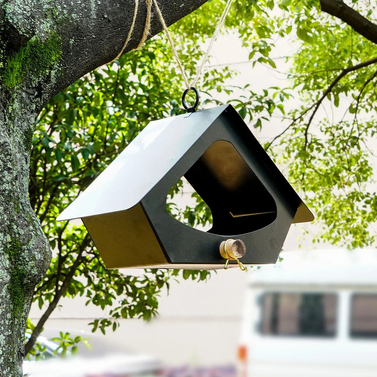 European-style iron bird nest with anti-rain roof in garden setting