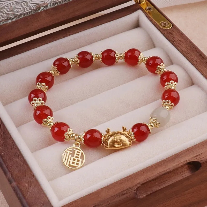 Women's floral glazed glass bracelet with animal zodiac charms in red, pink and white bead colour variations