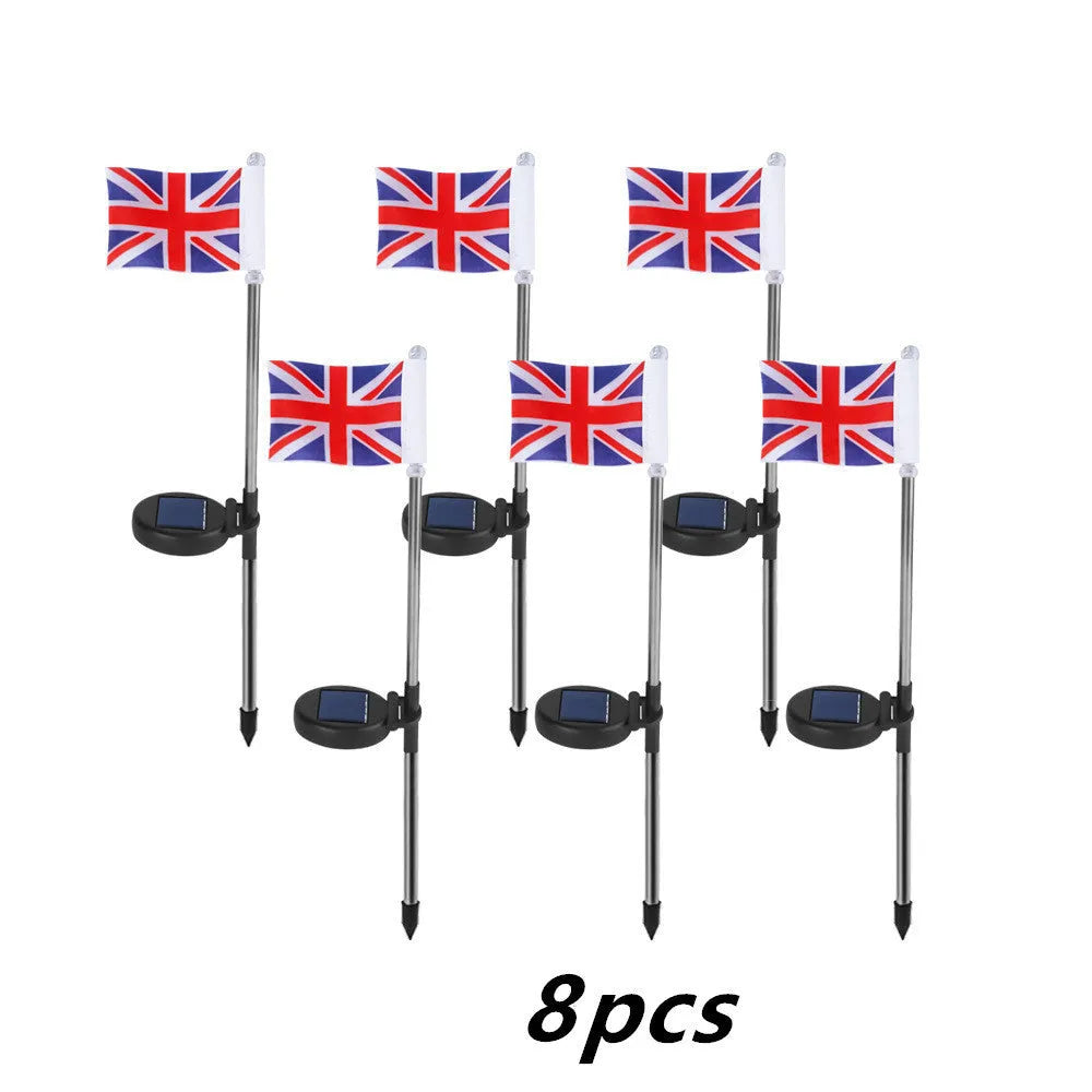 Solar-powered garden flag light displaying either American or British flag design with stainless steel pole and solar panel