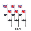 Solar-powered garden flag light displaying either American or British flag design with stainless steel pole and solar panel