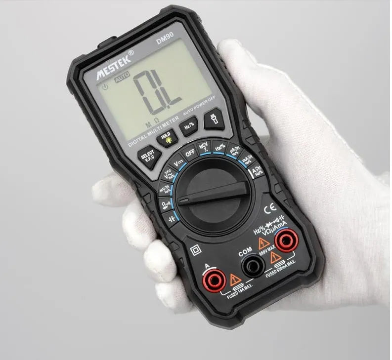 DM90A digital multimeter with display showing reading, test leads, and thermocouple probe on a workbench.